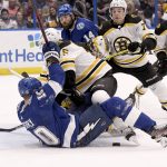 
              Boston Bruins defenseman Connor Clifton (75) knocks down Tampa Bay Lightning right wing Corey Perry (10) during the second period of an NHL hockey game Friday, April 8, 2022, in Tampa, Fla. (AP Photo/Jason Behnken)
            