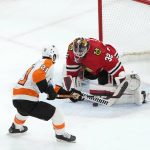 
              Chicago Blackhawks goaltender Kevin Lankinen (32) makes a save on a point-blank shot by Philadelphia Flyers' Scott Laughton (21) during the first period of an NHL hockey game Monday, April 25, 2022, in Chicago. (AP Photo/Charles Rex Arbogast)
            