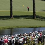 
              Tiger Woods putts on the 15th green during the final round at the Masters golf tournament on Sunday, April 10, 2022, in Augusta, Ga. (AP Photo/Charlie Riedel)
            
