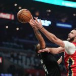 
              New Orleans Pelicans forward Larry Nance Jr., right, shoots as Los Angeles Clippers forward Norman Powell defends during the first half of an NBA basketball play-in tournament game Friday, April 15, 2022, in Los Angeles. (AP Photo/Mark J. Terrill)
            