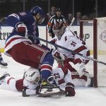 
              Carolina Hurricanes defenseman Brett Pesce (22) dives to stop an attempt by New York Rangers left wing Chris Kreider (20) on the goal during the second period of an NHL hockey game Tuesday, April 12, 2022, in New York. (AP Photo/Bebeto Matthews)
            
