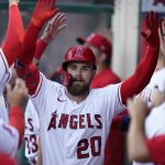 
              Los Angeles Angels' Jared Walsh (20) celebrates with teammates in the dugout after hitting a home run during the second inning of a baseball game against the Houston Astros in Anaheim, Calif., Saturday, April 9, 2022. (AP Photo/Ashley Landis)
            