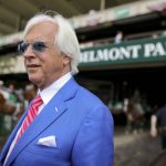 
              FILE - Trainer Bob Baffert walks out to the winner's circle after the Brooklyn Invitational Stakes horse race at Belmont Park, Saturday, June 9, 2018, in Elmont, N.Y. A retired New York State Supreme Court Justice has recommended a two-year suspension for trainer Bob Baffert after a New York Racing Association hearing. Judge O. Peter Sherwood, who served as the hearing officer for the case, released a report with his findings Wednesday, April 27, 2022, that will be sent to a three-member panel for consideration. (AP Photo/Mary Altaffer, File)
            