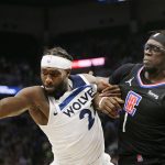 
              Minnesota Timberwolves guard Patrick Beverley (22) and Los Angeles Clippers guard Reggie Jackson (1) compete for the ball during the fourth quarter of an NBA basketball play-in game Tuesday, April 12, 2022, in Minneapolis. (AP Photo/Andy Clayton-King)
            
