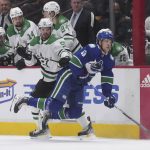 
              Dallas Stars' Tyler Seguin, left, checks Vancouver Canucks' Elias Pettersson, of Sweden, during the first period of an NHL hockey game in Vancouver, British Columbia, Monday, April 18, 2022. (Darryl Dyck/The Canadian Press via AP)
            