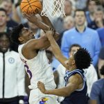 
              Kansas' David McCormack, left, shoots over Villanova's Jermaine Samuels during the first half of a college basketball game in the semifinal round of the Men's Final Four NCAA tournament, Saturday, April 2, 2022, in New Orleans. (AP Photo/Gerald Herbert)
            
