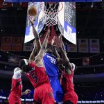 
              Philadelphia 76ers' Joel Embiid, center, got up for a shot against Toronto Raptors' Chris Boucher, from left, Precious Achiuwa and Pascal Siakam during the first half of Game 5 in an NBA basketball first-round playoff series, Monday, April 25, 2022, in Philadelphia. (AP Photo/Matt Slocum)
            