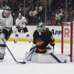 
              Vancouver Canucks goalie Spencer Martin, right, makes a save on a re-direct by Los Angeles Kings' Anze Kopitar during the first period of an NHL hockey game Thursday, April 28, 2022, in Vancouver, British Columbia. (Darryl Dyck/The Canadian Press via AP)
            