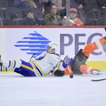 
              Buffalo Sabres' Jacob Bryson, left, and Philadelphia Flyers' Zack MacEwen fall to the ice during the second period of an NHL hockey game, Sunday, April 17, 2022, in Philadelphia. (AP Photo/Derik Hamilton)
            