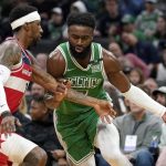 
              Washington Wizards guard Kentavious Caldwell-Pope, left, defends against Boston Celtics guard Jaylen Brown, right, in the first half of an NBA basketball game, Sunday, April 3, 2022, in Boston. (AP Photo/Steven Senne)
            