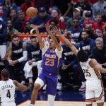 
              Phoenix Suns forward Cameron Johnson (23) shoots over New Orleans Pelicans guard Trey Murphy III (25) and guard Devonte' Graham (4) in the first half of Game 6 of an NBA basketball first-round playoff series, Thursday, April 28, 2022 in New Orleans. (AP Photo/Gerald Herbert)
            
