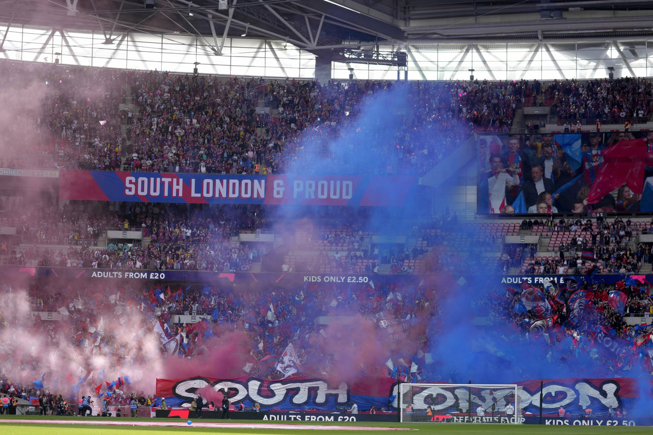 Crystal Palace fans release smoke bombs and wave flags before the start of the English FA Cup semif...