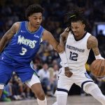 
              Memphis Grizzlies guard Ja Morant (12) tries to fend off Minnesota Timberwolves forward Jaden McDaniels (3) during the first half during Game 1 of a first-round NBA basketball playoff series Saturday, April 16, 2022, in Memphis, Tenn. (AP Photo/Brandon Dill)
            