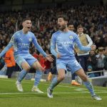 
              Manchester City's Bernardo Silva, right, celebrates after scoring his side's fourth goal during the Champions League semi final, first leg soccer match between Manchester City and Real Madrid at the Etihad stadium in Manchester, England, Tuesday, April 26, 2022. (AP Photo/Jon Super)
            