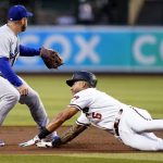 
              Arizona Diamondbacks' David Peralta (6) dives into second base with a double as Los Angeles Dodgers third baseman Max Muncy covers second base as he waits for a late throw during the first inning of a baseball game Tuesday, April 26, 2022, in Phoenix. (AP Photo/Ross D. Franklin)
            
