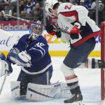 
              Toronto Maple Leafs goaltender Jack Campbell (36) and Washington Capitals right wing Garnet Hathaway (21) look back as the puck hits the side of the net during the third period of an NHL hockey game Thursday, April 14, 2022, in Toronto. (Frank Gunn/The Canadian Press via AP)
            