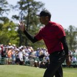 
              Tiger Woods waves to spectators on the 18th green after his final round at the Masters golf tournament on Sunday, April 10, 2022, in Augusta, Ga. (AP Photo/Jae C. Hong)
            