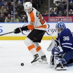 
              Toronto Maple Leafs goaltender Jack Campbell (36) makes a save as Philadelphia Flyers forward James van Riemsdyk (25) waits to pounce on the rebound during the third period of an NHL hockey game Tuesday, April 19, 2022 in Toronto. (Nathan Denette/The Canadian Press via AP)
            