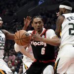 
              Portland Trail Blazers guard Keon Johnson, center, drive to the basket on Utah Jazz forward Danuel House Jr., left, and forward Royce O'Neale, right, during the first half of an NBA basketball game in Portland, Ore., Sunday, April 10, 2022. (AP Photo/Steve Dykes)
            
