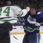 
              Vancouver Canucks' Luke Schenn, right, and Dallas Stars' Jamie Benn fight during the second period of an NHL hockey game in Vancouver, British Columbia, Monday, April 18, 2022. (Darryl Dyck/The Canadian Press via AP)
            