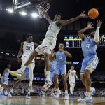 
              Kansas forward David McCormack vies for a loose ball with North Carolina guard R.J. Davis during the first half of a college basketball game in the finals of the Men's Final Four NCAA tournament, Monday, April 4, 2022, in New Orleans. (AP Photo/David J. Phillip)
            