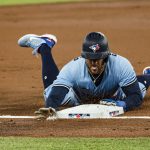 
              Toronto Blue Jays center fielder George Springer (4) slides into third base advancing on a single by Bo Bichette during the first inning of a MLB baseball game against the Toronto Blue Jays in Toronto on Sunday, April 17, 2022. (Christopher Katsarov/The Canadian Press via AP)
            