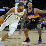 
              New Orleans Pelicans forward Brandon Ingram (14) dries as Phoenix Suns guard Cameron Payne (15) defends during the second half of Game 2 of an NBA basketball first-round playoff series, Tuesday, April 19, 2022, in Phoenix. (AP Photo/Matt York)
            