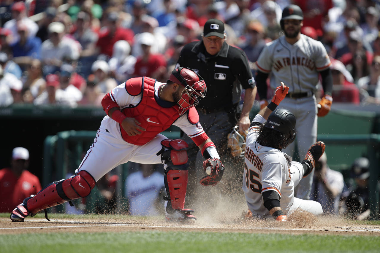 San Francisco Giants Brandon Crawford (35) slides safely into home plate on an RBI single by Wilmer...