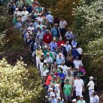 
              Spectators walk along the sixth fairway during a practice round for the Masters golf tournament on Monday, April 4, 2022, in Augusta, Ga. (AP Photo/Matt Slocum)
            