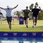 
              Jennifer Kupcho, center, jumps in the water with her husband Jay Monahan, right, and caddie David Eller after Kupcho's win in the LPGA Chevron Championship golf tournament Sunday, April 3, 2022, in Rancho Mirage, Calif. (AP Photo/Marcio Jose Sanchez)
            
