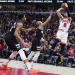
              Chicago Bulls guard Zach LaVine, right, shoots against Milwaukee Bucks guard Jevon Carter, center, and forward Giannis Antetokounmpo during the first half of Game 3 of a first-round NBA basketball playoff series Friday, April 22, 2022, in Chicago. (AP Photo/Nam Y. Huh)
            