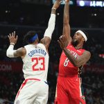 
              New Orleans Pelicans forward Naji Marshall, right, shoots as Los Angeles Clippers forward Robert Covington defends during the first half of an NBA basketball game Sunday, April 3, 2022, in Los Angeles. (AP Photo/Mark J. Terrill)
            