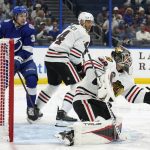 
              Chicago Blackhawks goaltender Kevin Lankinen (32) makes a glove save as =pcx7n= keeps Tampa Bay Lightning left wing Brandon Hagel (38) from a rebound during the second period of an NHL hockey game Friday, April 1, 2022, in Tampa, Fla. (AP Photo/Chris O'Meara)
            