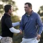 
              Charl Schwartzel, of South Africa, shakes hands with Scottie Scheffler on the 18th hole during the third round at the Masters golf tournament on Saturday, April 9, 2022, in Augusta, Ga. (AP Photo/David J. Phillip)
            