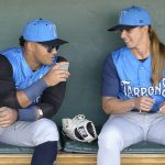 
              Tampa Tarpons manager Rachel Balkovec, right, chats in the dugout with center fielder Jasson Dominguez, while making her debut as a minor league manager of the Tarpons, a Single-A affiliate of the New York Yankees, before a baseball game against the Lakeland Flying Tigers, Friday, April 8, 2022, in Lakeland, Fla. Balkovic is the first female to manage a professional baseball team. (AP Photo/Phelan M. Ebenhack)
            