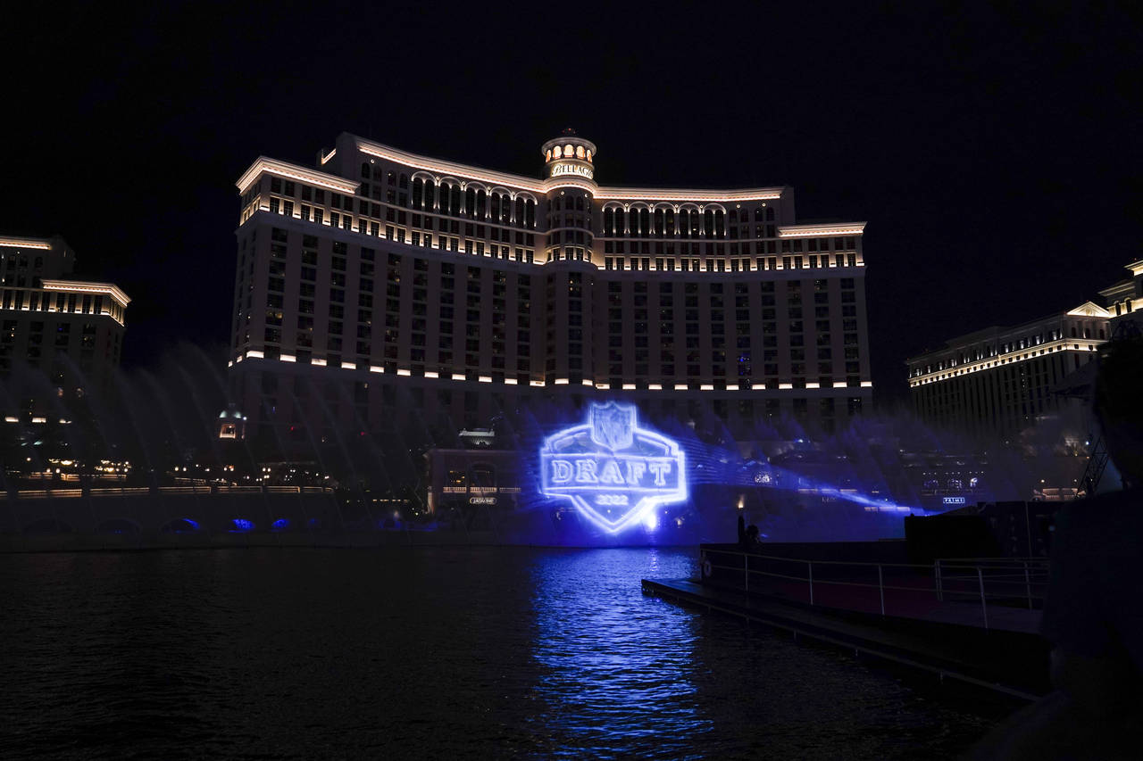 A logo of the 2022 NFL football draft is projected at the Fountains of Bellagio on Wednesday, April...