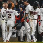 
              Minnesota Twins's Luis Arraez (2) cerebrates with teammates after scoring after the Chicago White Sox commit two errors on a play during the eighth inning of a baseball game, Friday, April 22, 2022, in Minneapolis. (AP Photo/Craig Lassig)
            