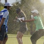 
              Jennifer Kupcho, second from left, is doused with water on the18th hole after winning the LPGA Chevron Championship golf tournament Sunday, April 3, 2022, in Rancho Mirage, Calif. (AP Photo/Marcio Jose Sanchez)
            
