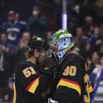 Vancouver Canucks' Sheldon Dries, left, and Spencer Martin celebrate after the Canucks defeated the Seattle Kraken 5-2 in an NHL hockey game Tuesday, April 26, 2022, in Vancouver, British Columbia. (Darryl Dyck/The Canadian Press via AP)