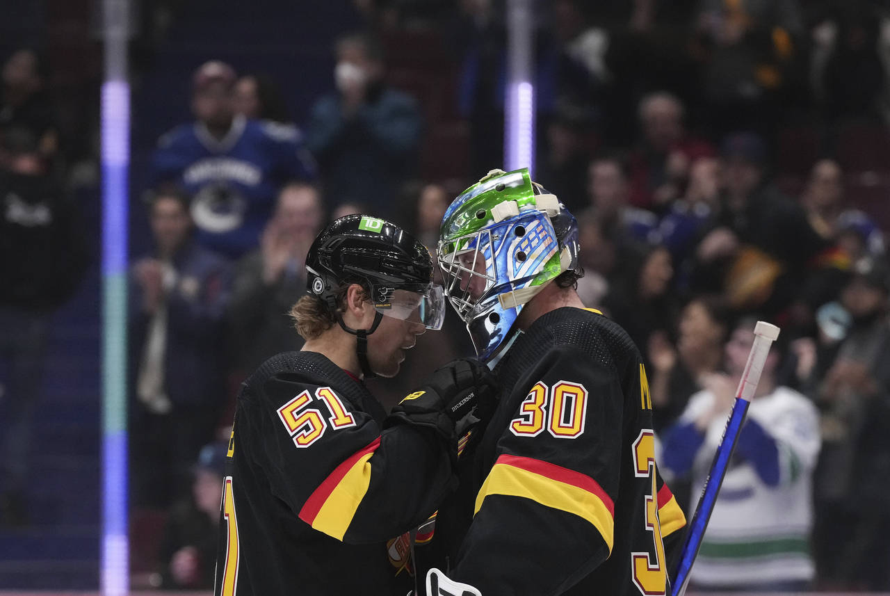 Vancouver Canucks' Sheldon Dries, left, and Spencer Martin celebrate after the Canucks defeated the...
