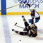 
              Pittsburgh Penguins' Jake Guentzel (59) tumbles in front of Colorado Avalanche's Artturi Lehkonen (62) as he tries to get to the puck during the third period of an NHL hockey game, Tuesday, April 5, 2022, in Pittsburgh. The Avalanche won 6-4. (AP Photo/Keith Srakocic)
            
