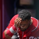 
              Washington Nationals designated hitter Nelson Cruz (23) wipes water from his face in the dugout during the fifth inning of a baseball game against Atlanta Braves, Wednesday, April 13, 2022, in Atlanta. (AP Photo/Brynn Anderson)
            
