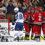 
              Carolina Hurricanes' Seth Jarvis (24) celebrates his goal with teammates Teuvo Teravainen (86), Sebastian Aho (20) and Ian Cole (28) as Winnipeg Jets' Nate Schmidt (88) stands near Jets goaltender Eric Comrie (1) during the third period of an NHL hockey game in Raleigh, N.C., Thursday, April 21, 2022. (AP Photo/Karl B DeBlaker)
            