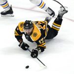 
              Boston Bruins left wing Nick Foligno tries to keep control of the puck after getting knocked to the ice by Buffalo Sabres defenseman Casey Fitzgerald during the second period of an NHL hockey game, Thursday, April 28, 2022, in Boston. (AP Photo/Charles Krupa)
            