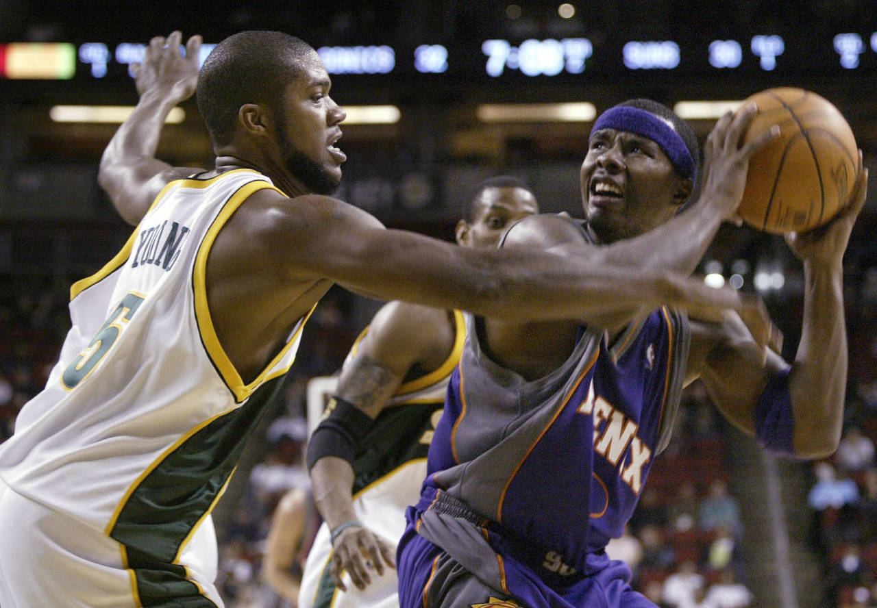 FILE - Seattle SuperSonics' Galen Young (5) guards Phoenix Suns' Quentin Richardson during the firs...