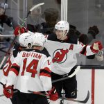 
              New Jersey Devils defenseman Damon Severson (28) celebrates a goal with right wing Nathan Bastian (14) and center Michael McLeod, against the Seattle Kraken during the third period of an NHL hockey game, Saturday, April 16, 2022, in Seattle. (AP Photo/John Froschauer)
            