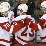 
              Detroit Red Wings center Oskar Sundqvist (70) celebrates his goal with teammates during the first period of an NHL hockey game against the New Jersey Devils Sunday, April 24, 2022, in Newark, N.J. (AP Photo/Bill Kostroun)
            