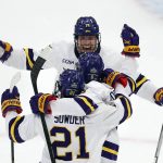 
              Minnesota State's Sam Morton (6) celebrates his goal with Lucas Sowder (21) and Ryan Sandelin (14) during the first period of the NCAA men's Frozen Four championship college hockey game against Denver, Saturday, April 9, 2022, in Boston. (AP Photo/Michael Dwyer)
            