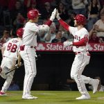 
              Los Angeles Angels' Taylor Ward, right, is congratulated by Shohei Ohtani after hitting a solo home run during the fifth inning of a baseball game against the Cleveland Guardians Monday, April 25, 2022, in Anaheim, Calif. (AP Photo/Mark J. Terrill)
            