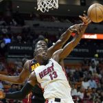 
              Atlanta Hawks center Clint Capela, rear, and Miami Heat center Bam Adebayo (13) reach for the ball during the first half of an NBA basketball game Friday, April 8, 2022, in Miami. (AP Photo/Lynne Sladky)
            